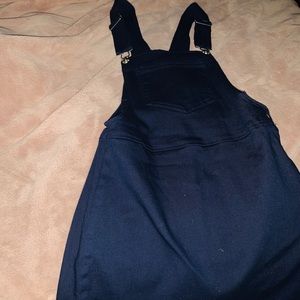 A woman’s small navy blue overall dress